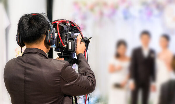 professional videographer recording wedding ceremony day